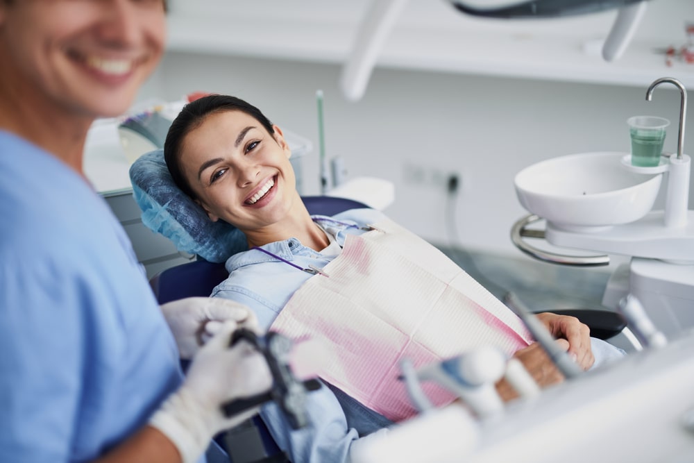 charming girl sitting in dentist chair