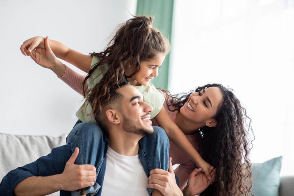 Family Of Three Having Fun Together At Home