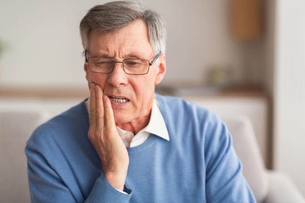 Elderly Man Having Toothache Touching