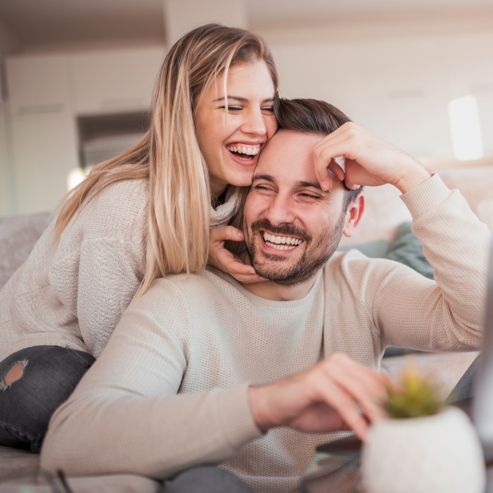 young couple working on laptop at home