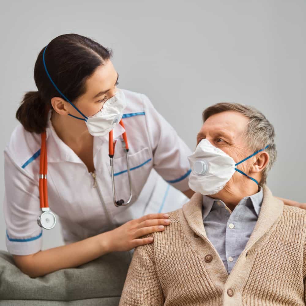 Doctor and senior man wearing facemasks