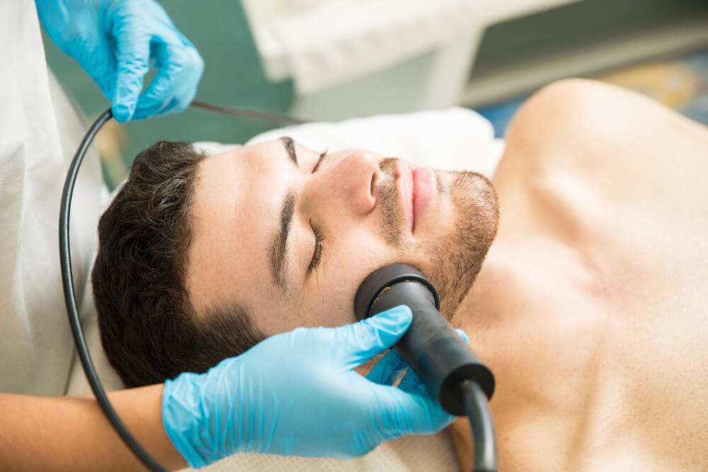 young man getting facial rejuvenation therapy