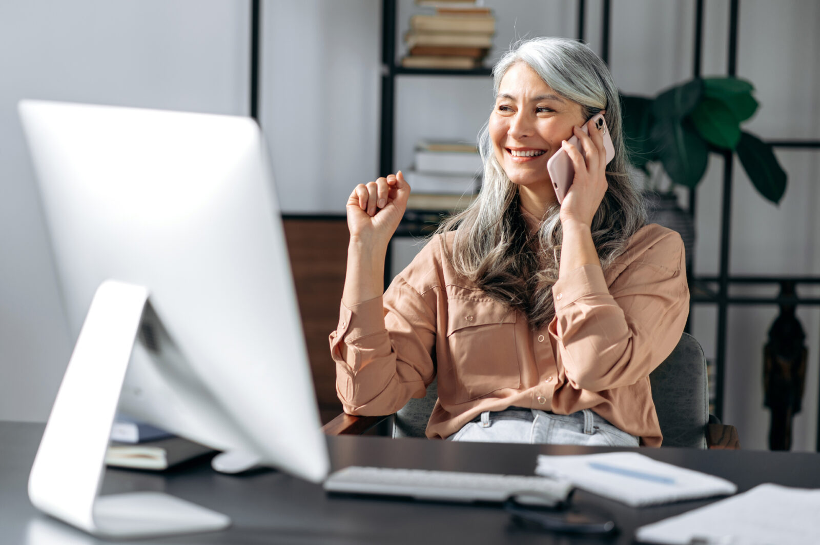 Successful mature business woman talking on phone