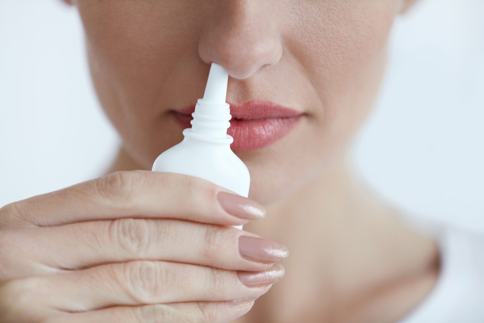 woman using nasal spray