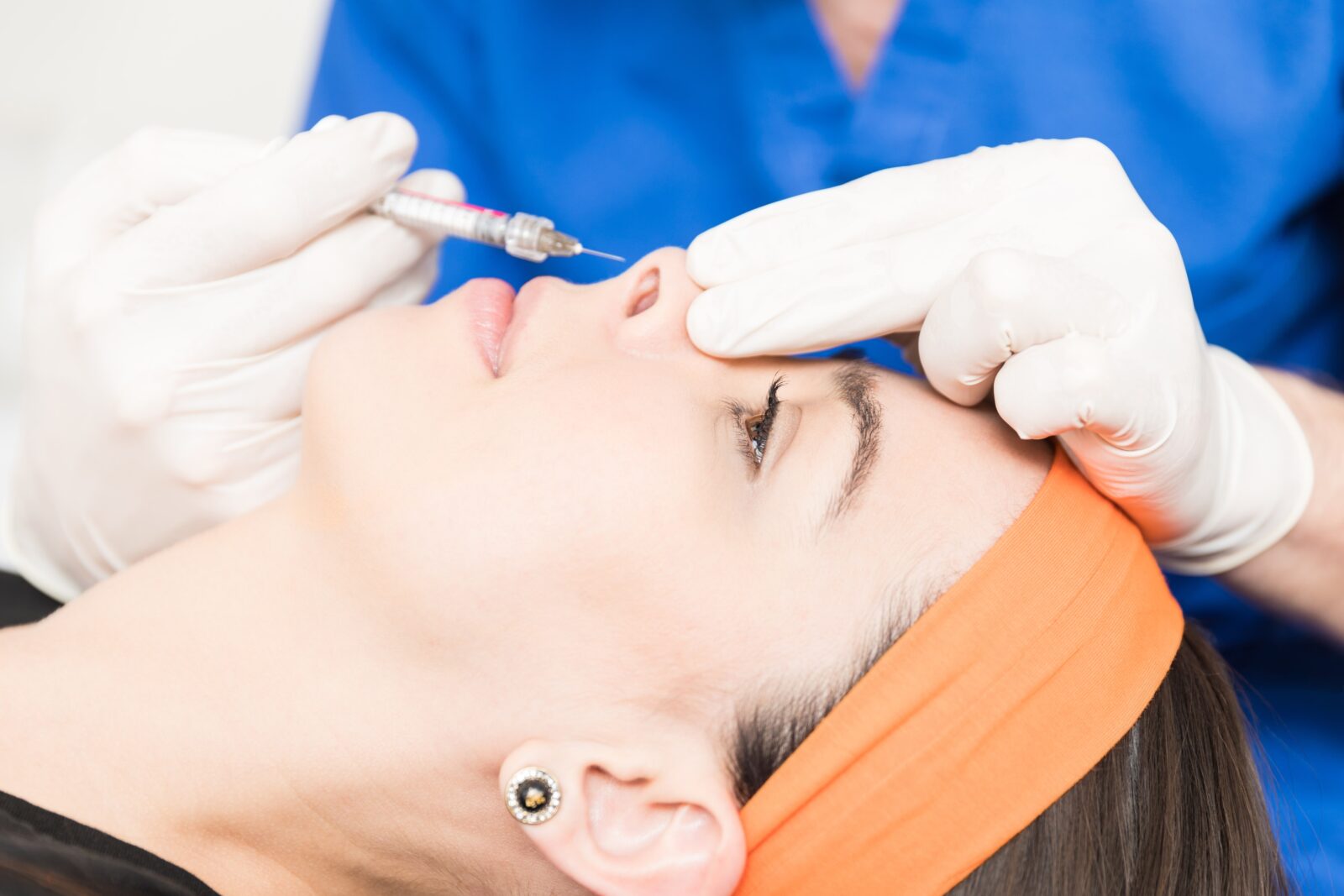 side profile of a woman have dermal fillers injected into her nose
