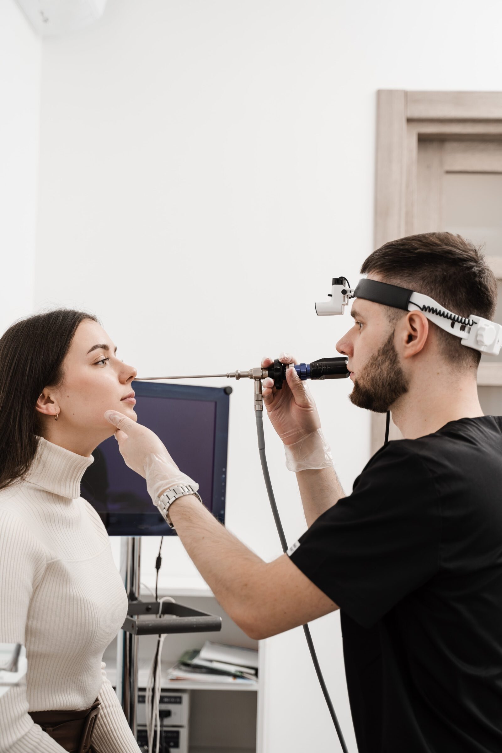 woman having a nasal endoscopy performed by an ENT