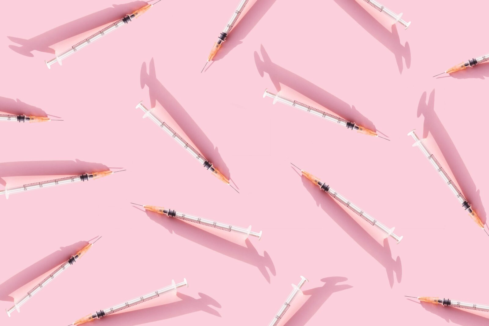 Creative medicinal pattern from syringes of pink background. 