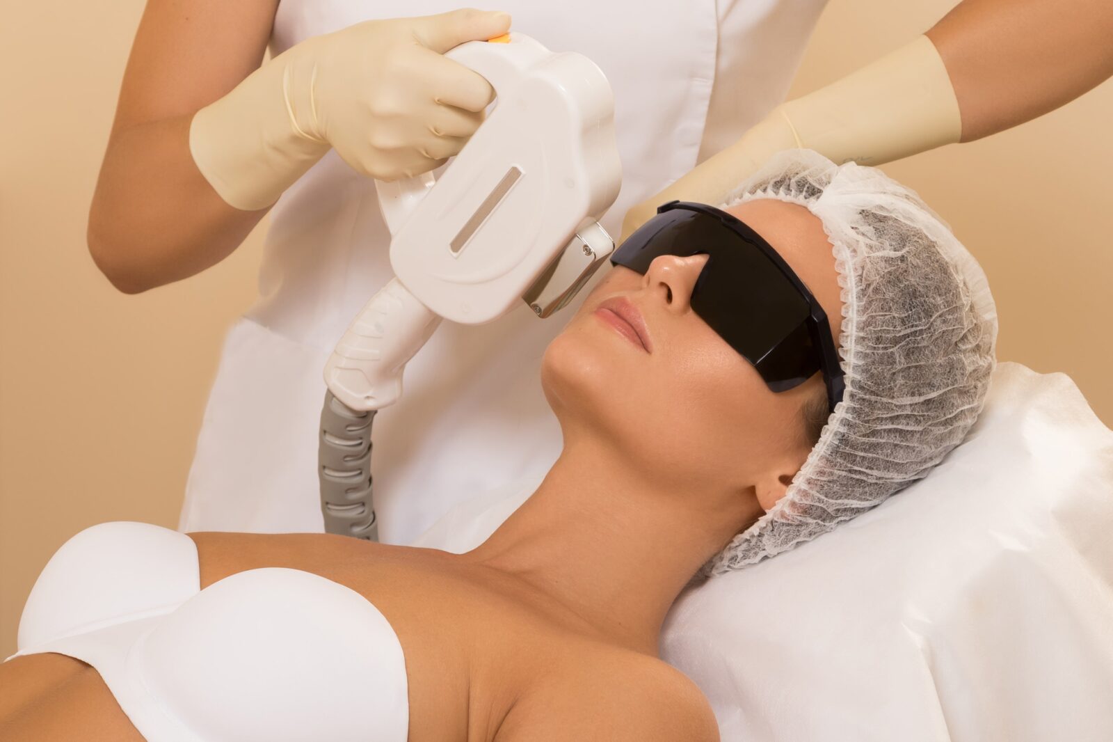 woman having light treatment with protective sunglasses