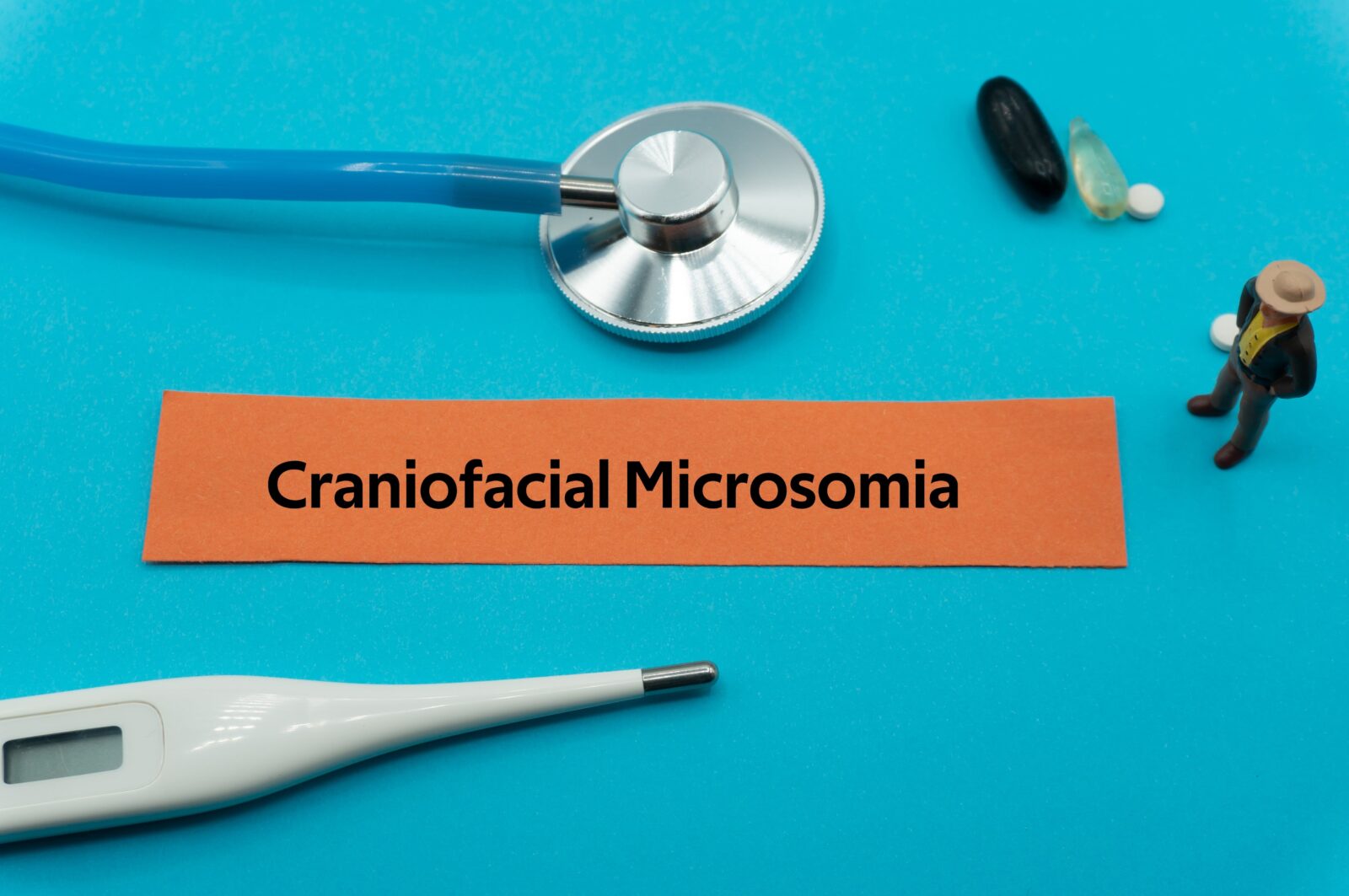 Craniofacial Microsomia.The word is written on a slip of colored paper. health terms, health care words, medical terminology. wellness Buzzwords. disease acronyms.