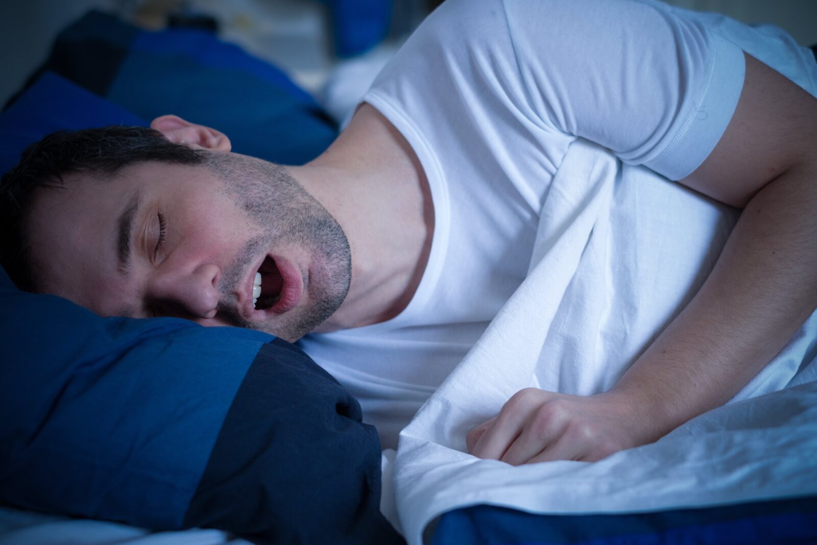 man snoring in bed