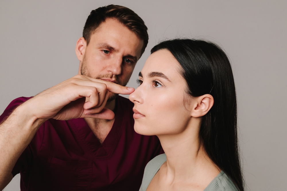 Rhinoplasty. Woman is going through nose surgery to constantly remove dorsal hump. Rhinoplasty to improve appearance of nose