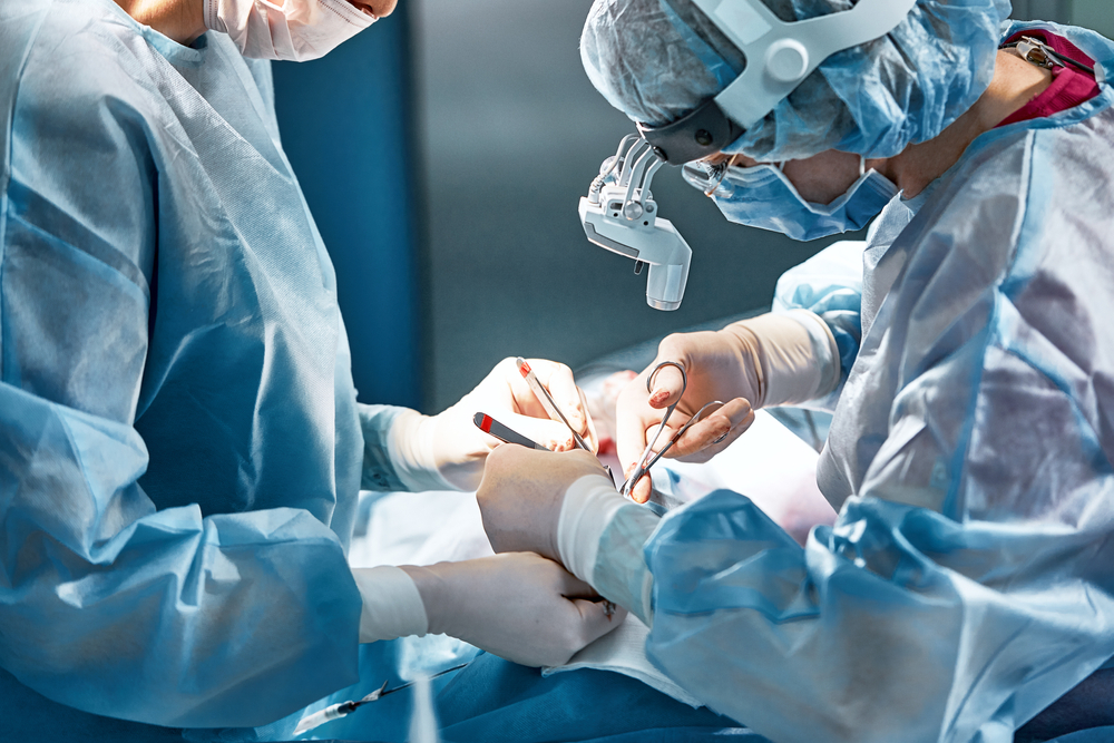 Rhinoplasty men, the surgeons gloved hands hold the instruments during nose surgery