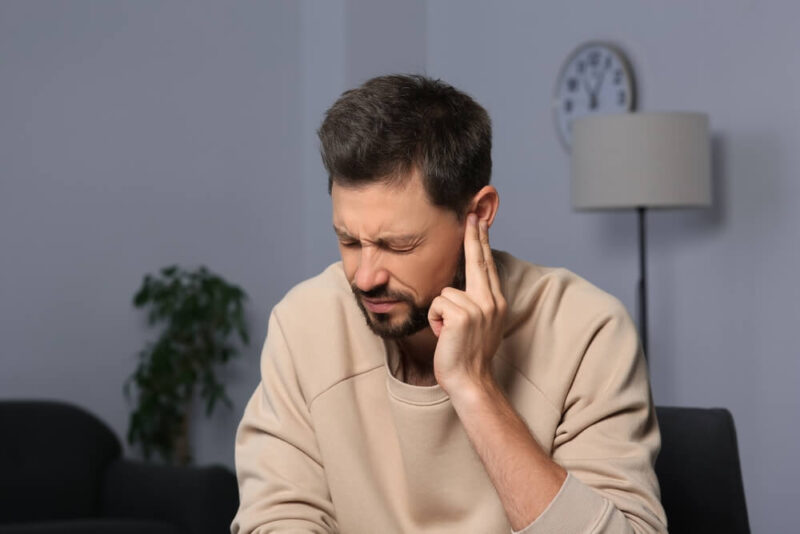 man suffering from tinnitus