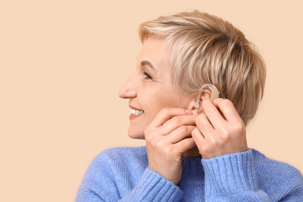 older woman wearing hearing aid