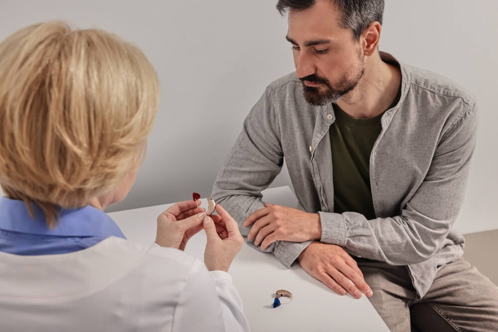 patient receiving a hearing aid