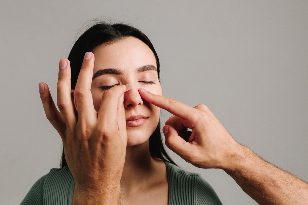 Rhinoplasty. Applying bandage on nose after surgery to support its shape, decrease swelli