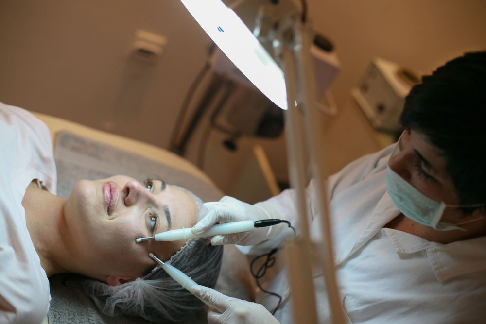 Young woman having facelift in beauty salon
