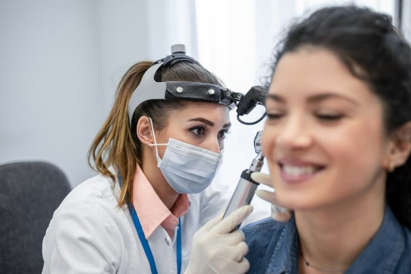 Hearing exam for a woman. Diagnosis of impairment and hearing testing in adults