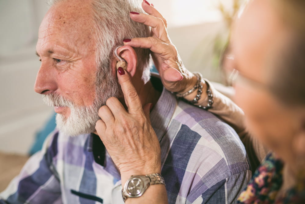 Older man and woman or pensioners with a hearing problem