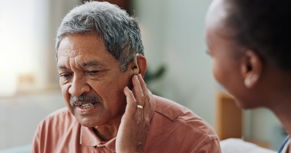 Nurse, man and hearing aid on ear for medical support, wellness and innovation of disability