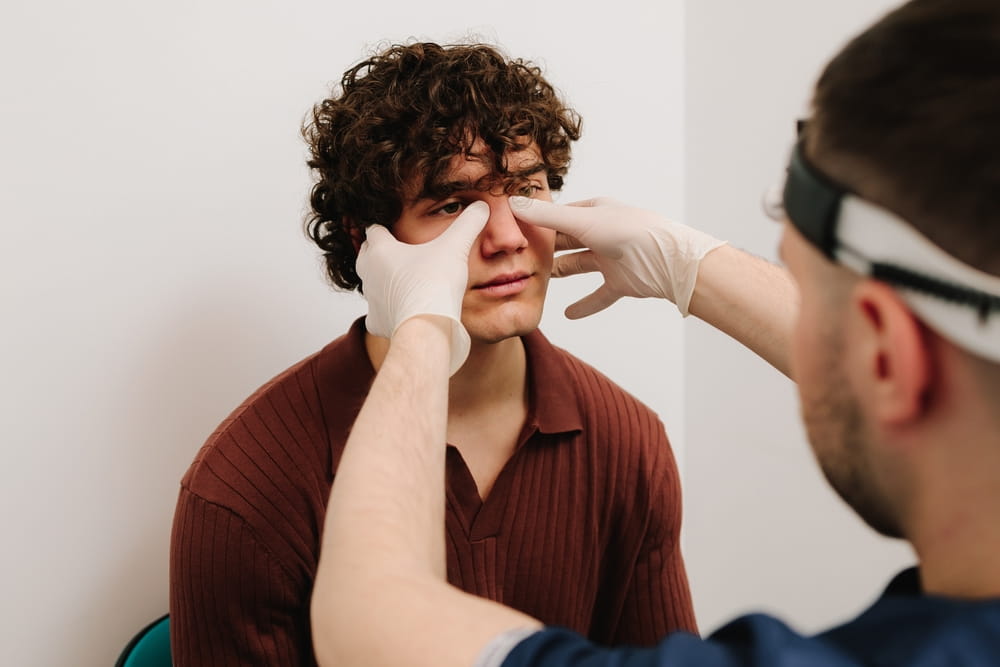 ENT doctor examine nose of male patient before rhinoplasty surgery. palpation of the nasal septum.