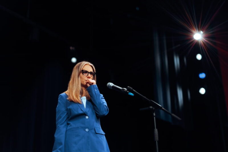 Woman clears her Throat before Giving a Public Speech Anxious person delivering a speech having a nervous twitch