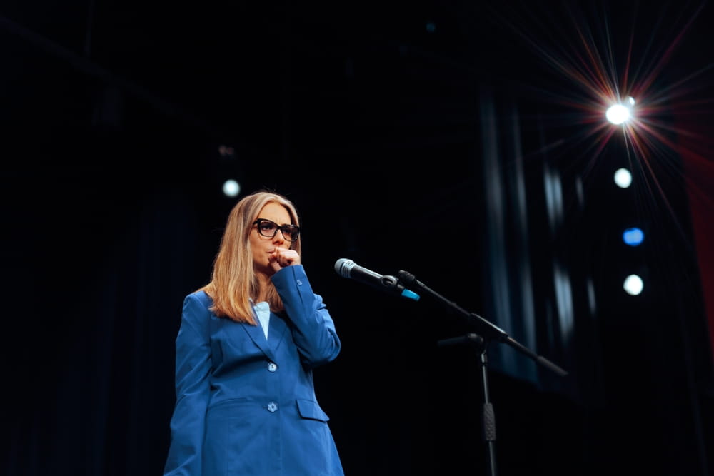 Woman clears her Throat before Giving a Public Speech Anxious person delivering a speech having a nervous twitch