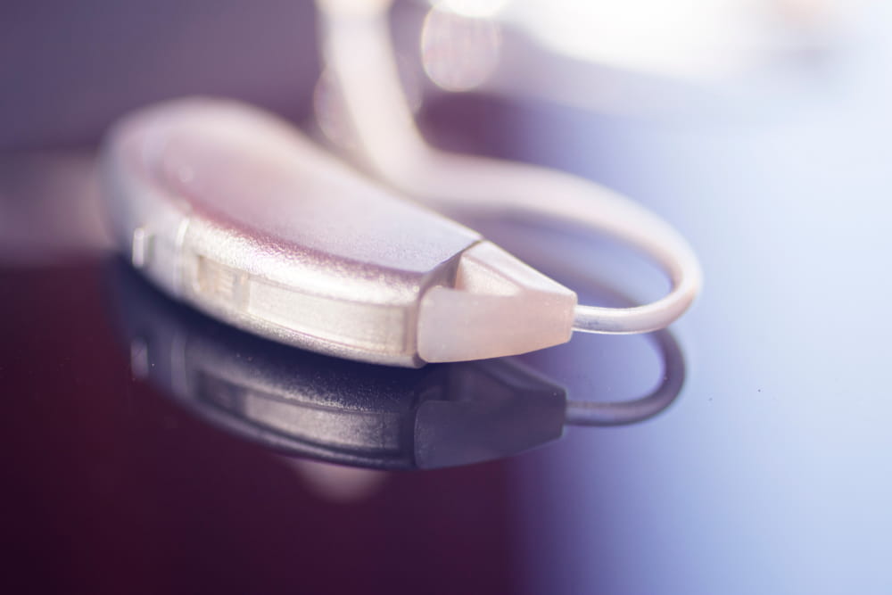 Audiophone modern high technology deafness equipment in the ear digital hearing aid closeup isolated.