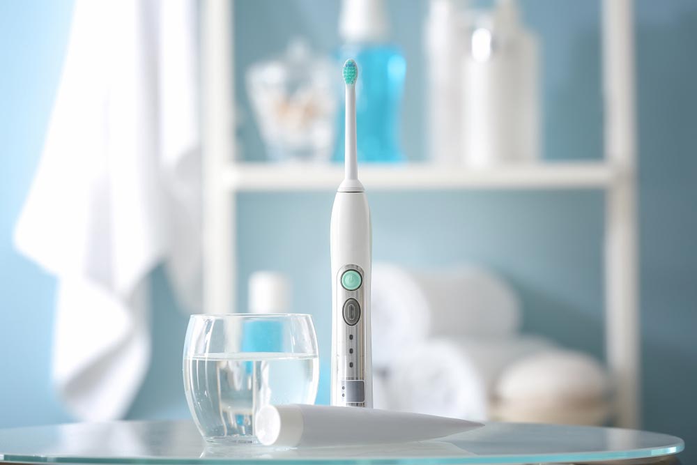 Electric toothbrush with paste and glass of water