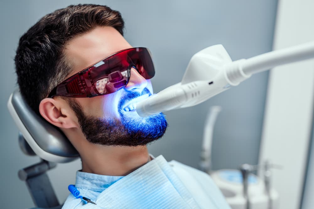 man undergoing laser tooth whitening treatment