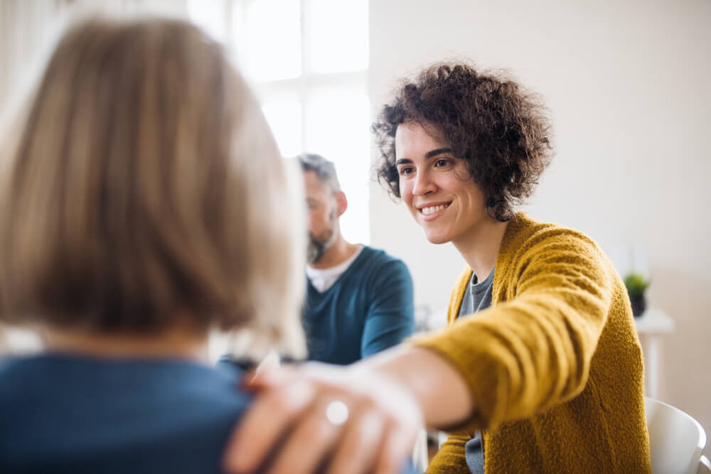 People sitting in a circle during group therapy