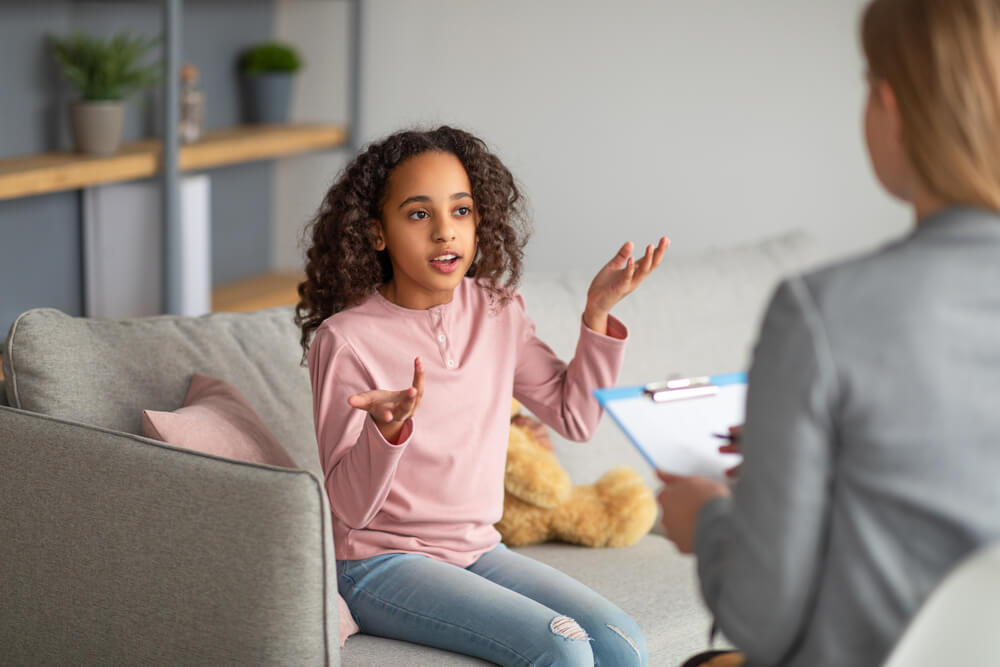 Cute girl visiting psychotherapist