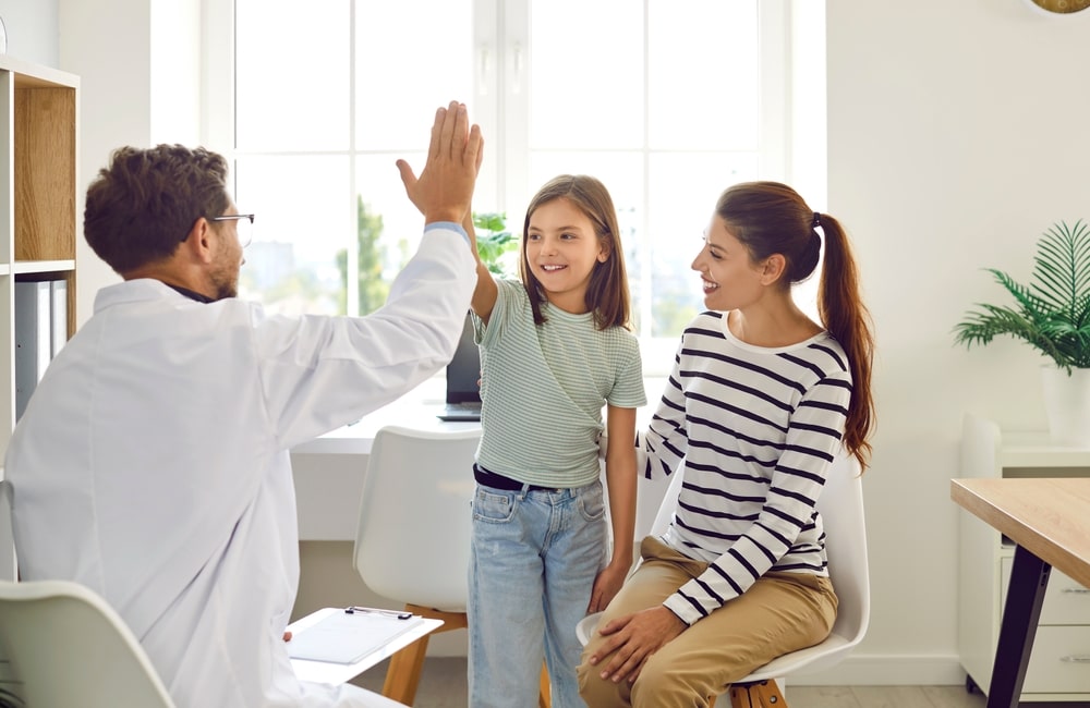 Happy Child, Parent, and Doctor Altogether