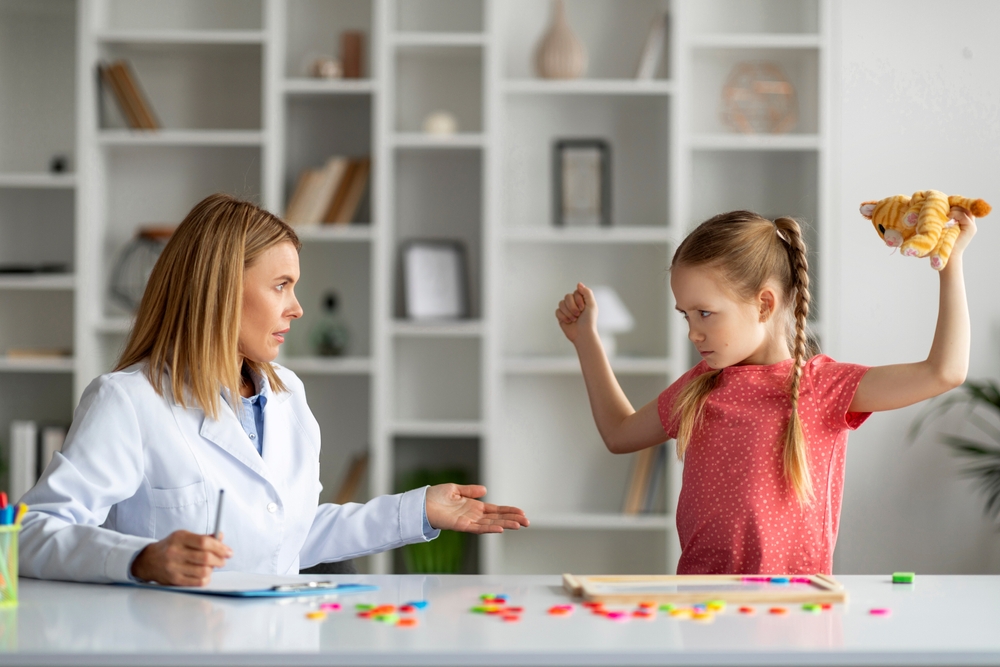 Disobedient bad tempered little girl throwing tantrum at appointment meeting with psychologist