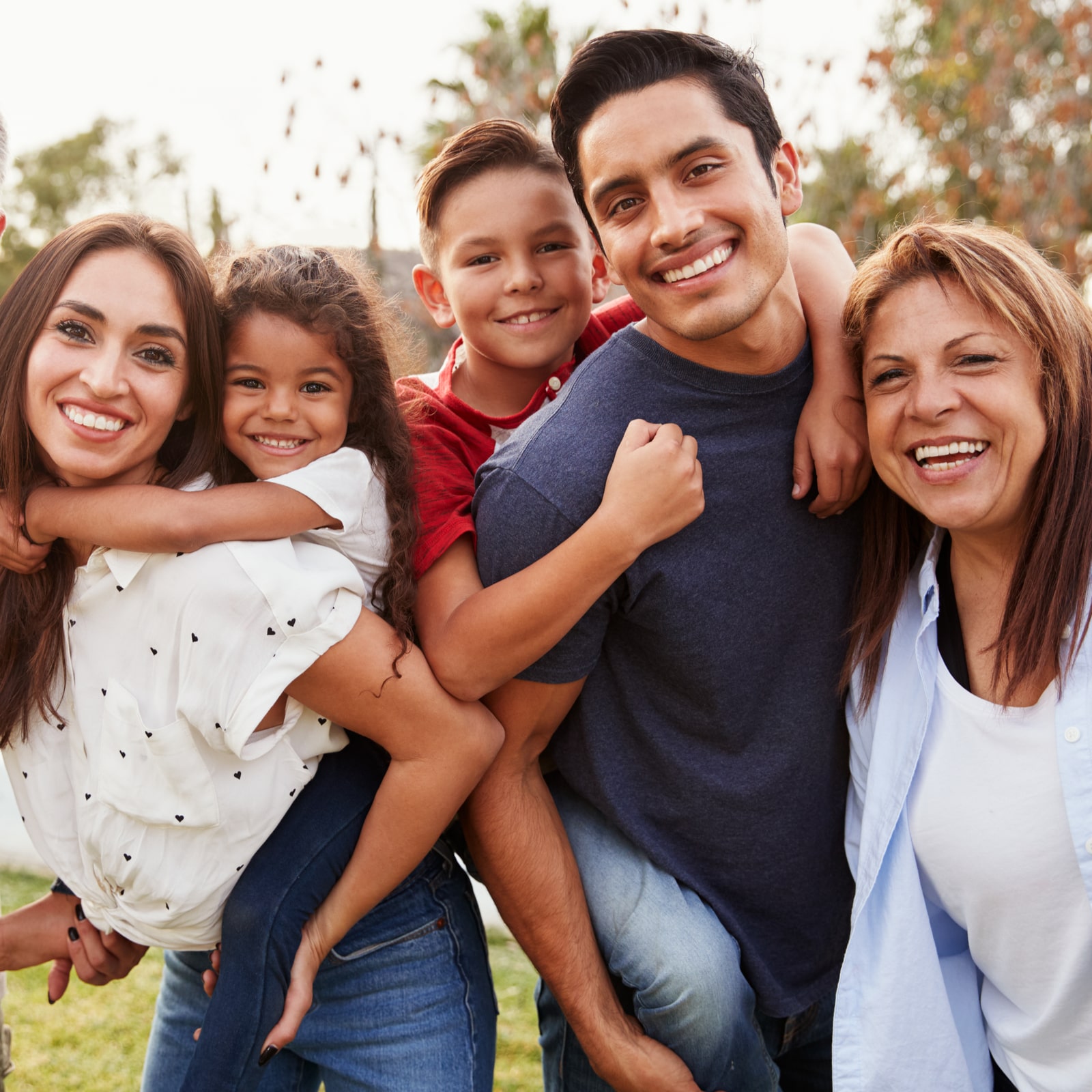 Three generation Hispanic family standing in the park