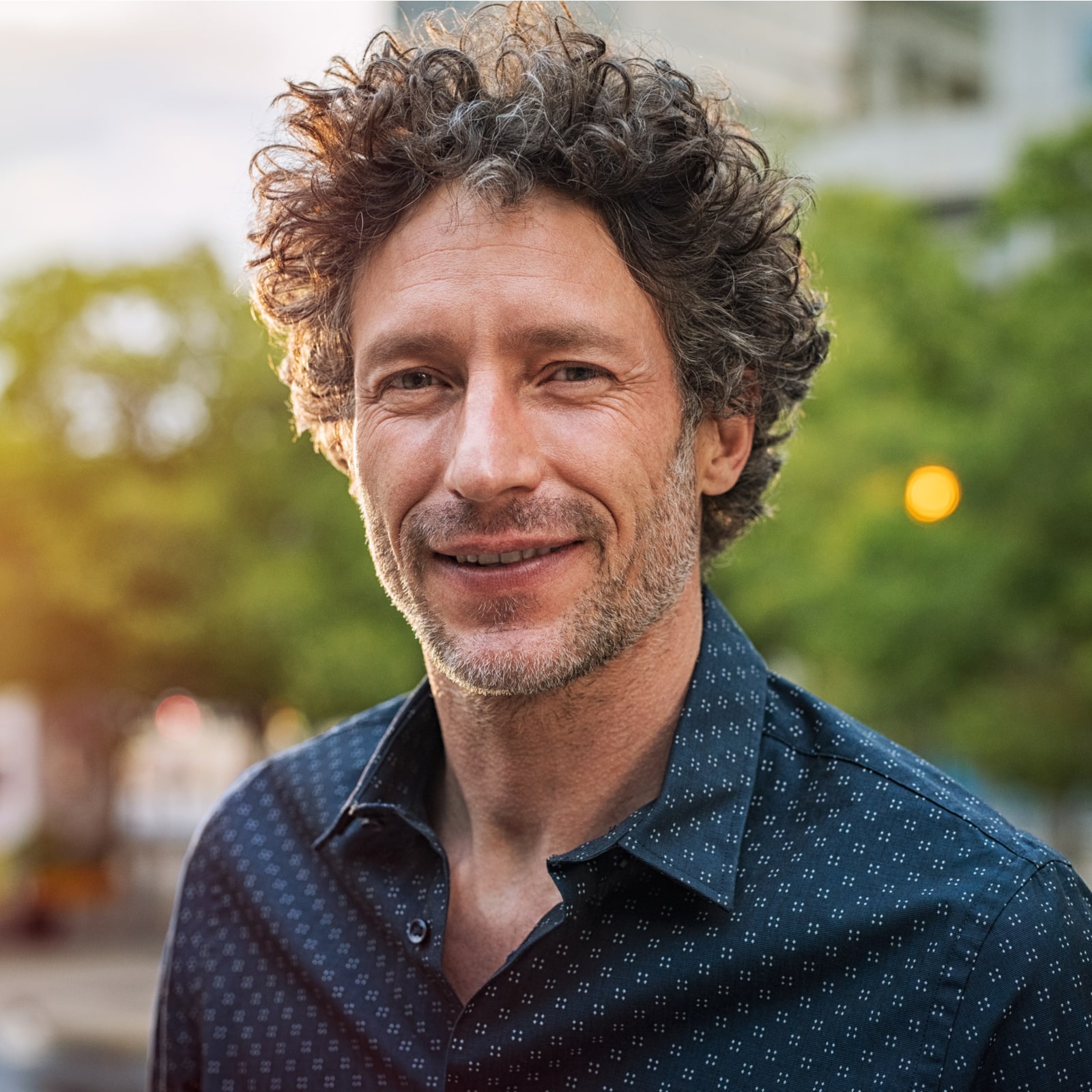 Senior man with beard feeling confident at sunset