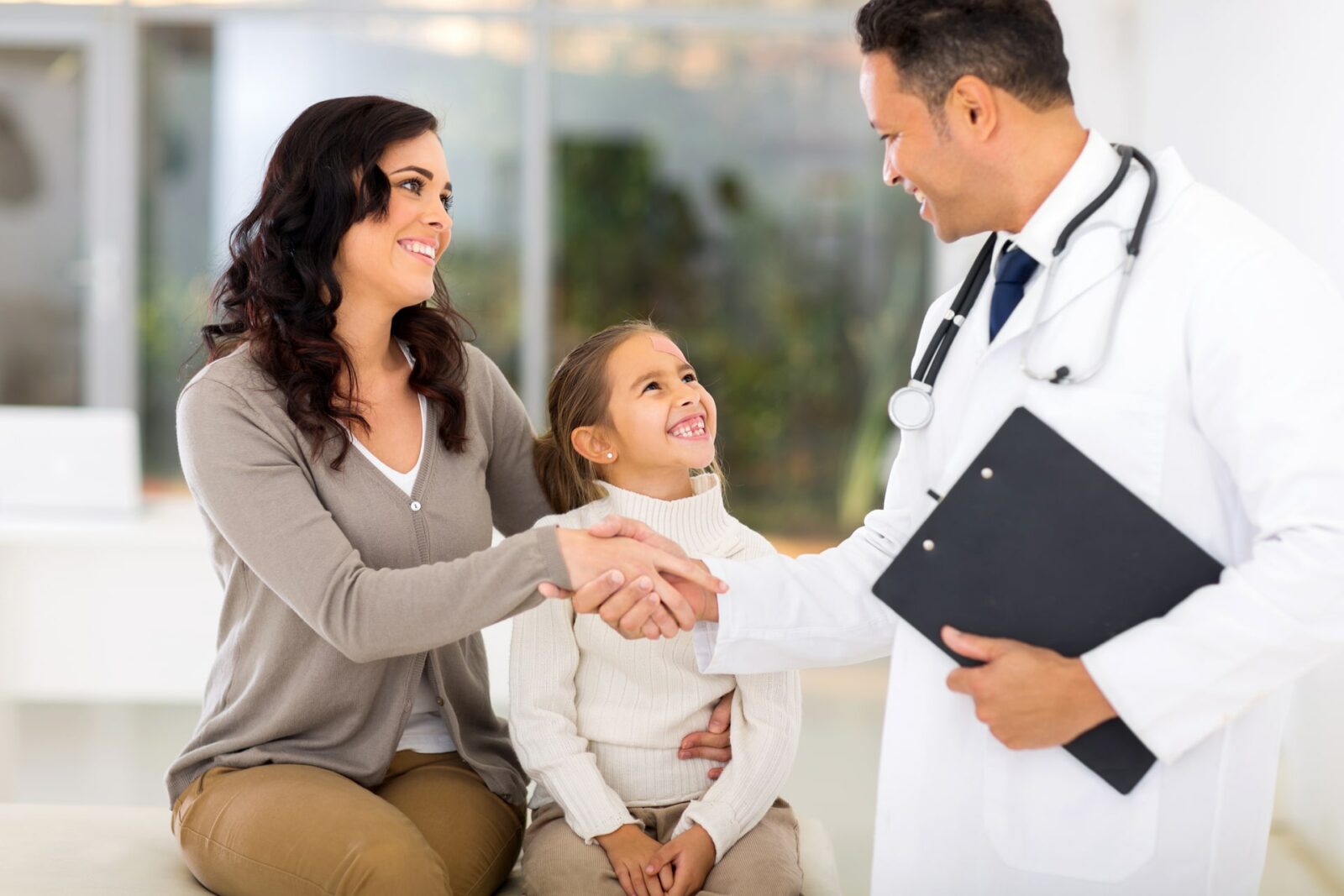 friendly male paediatrician greeting patient's mother