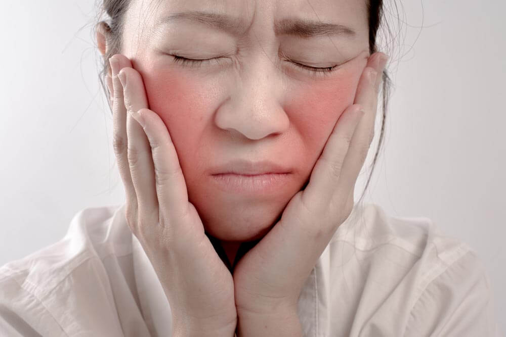 woman has a pain in toothache