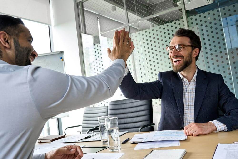 Two happy mans giving high-five