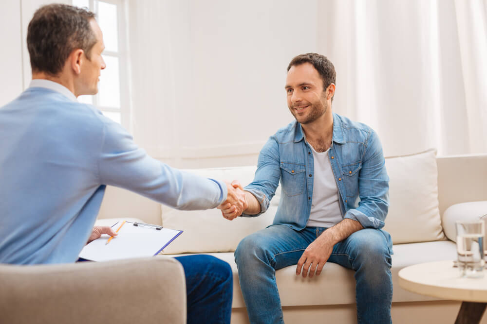 confident male patient saying goodbye to doctor