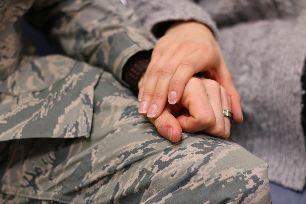 Military couple holding hands