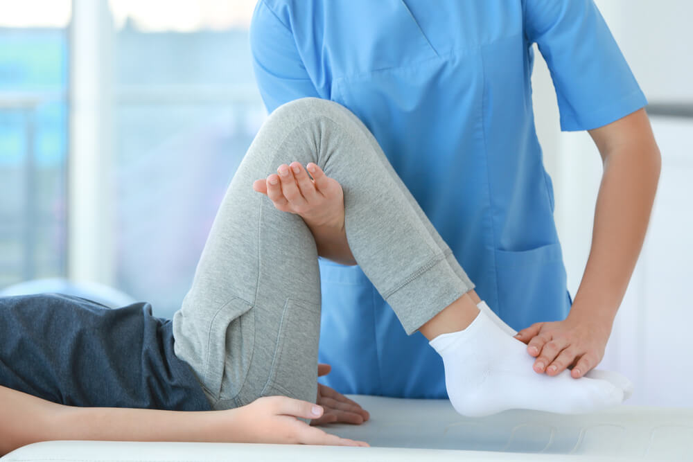 Physiotherapist working with patient in clinic