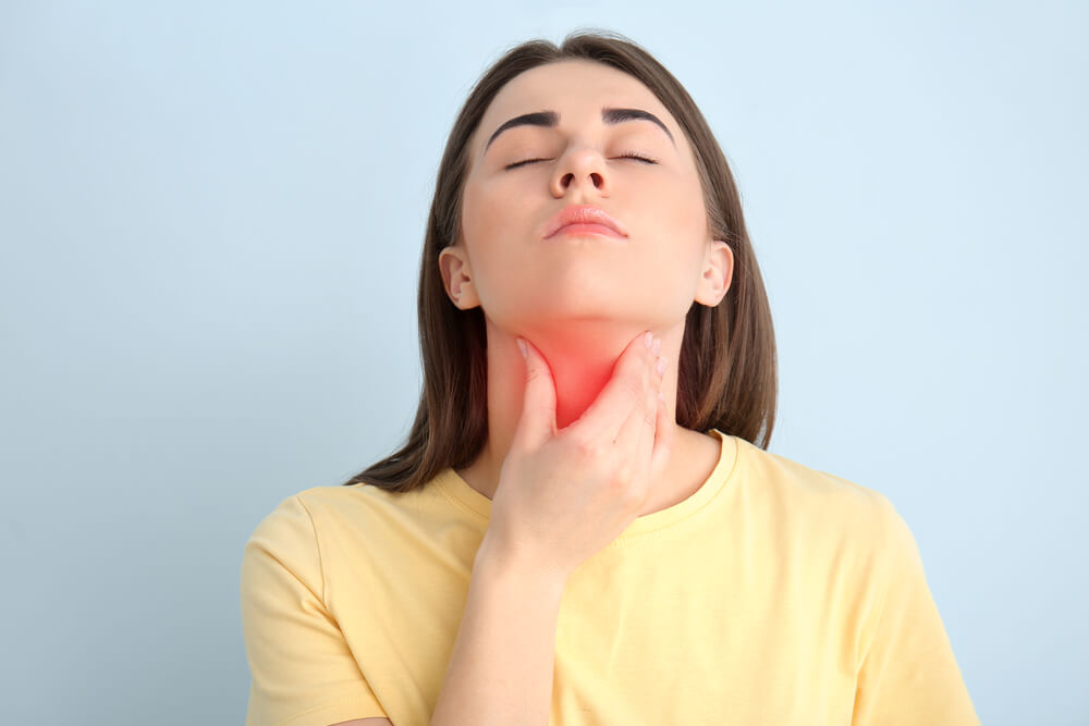 Young woman checking thyroid gland