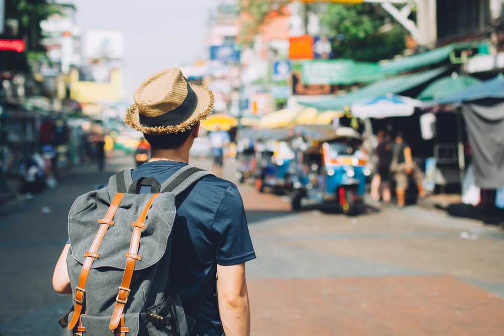 Young traveling backpacker in Road