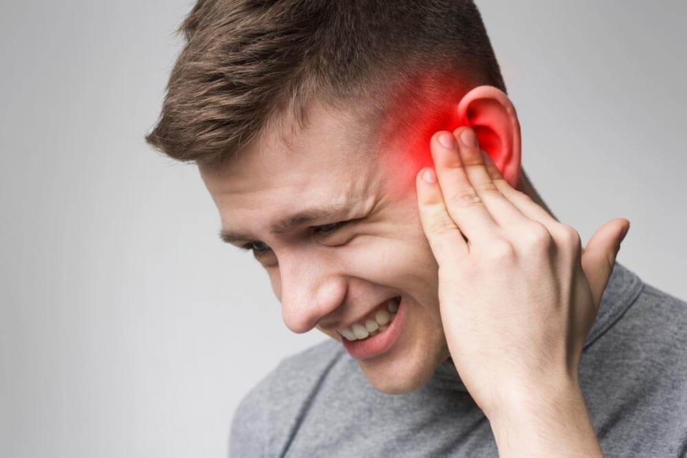 Young man with sore ear