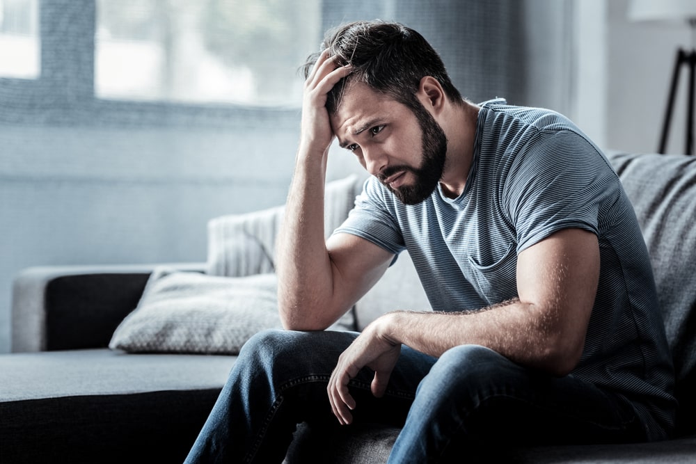 Sad unhappy handsome man sitting