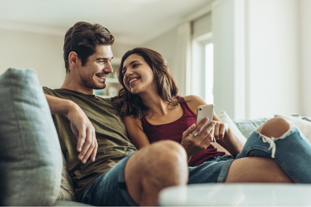 couple sitting on sofa at home