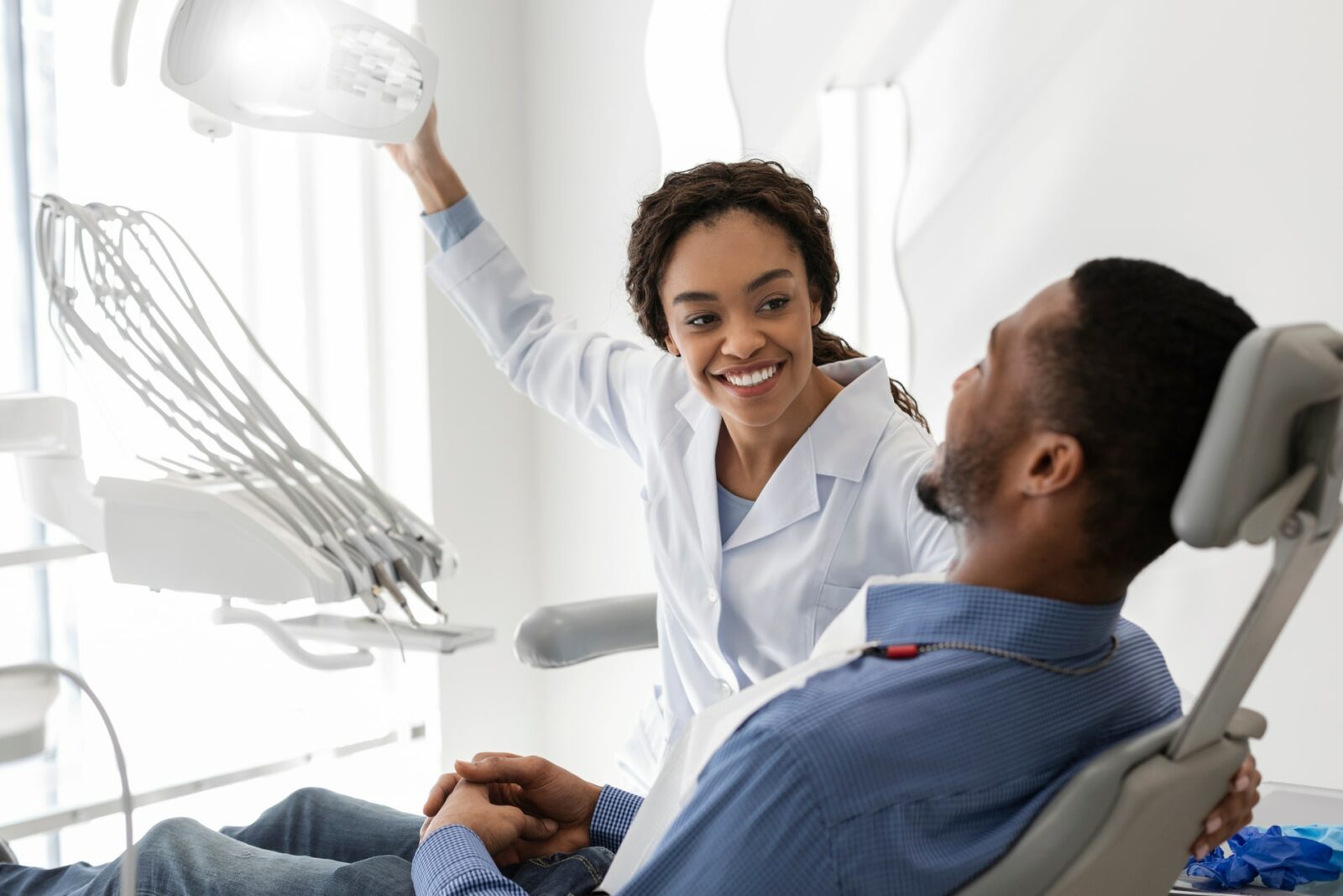 woman dentist greeting male patient