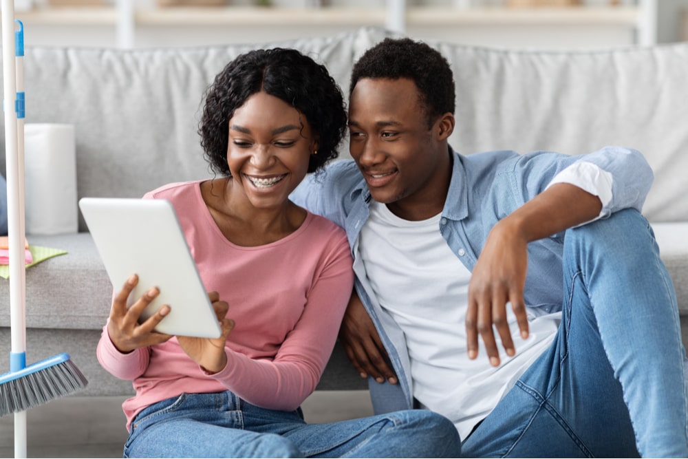 Smiling couple with digital tablet