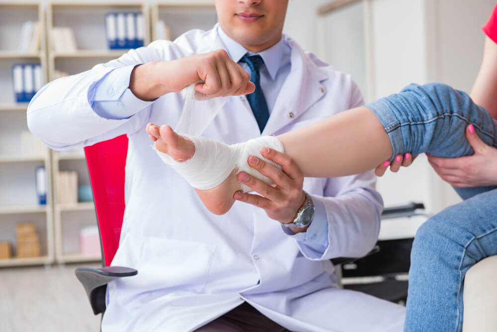 Doctor and patient during check-up for injury in hospital